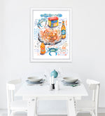 steamed blue crab recipe fine art print in watercolor featuring the ingredients and the finished dish, along with handwritten instructions in English. The framed poster hanging in a dining space.