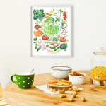 hand painted watercolor print featuring many fresh vegetables and " Framers Market " is hand written in the center of the painting. The print is framed in a dining space