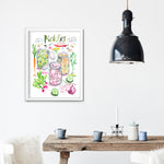 pickled vegetables recipe fine art print in watercolor featuring the ingredients and three jars of mixed veggies, along with handwritten instructions in English. The framed poster hanging in a dining space.