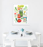 Spanish and Puerto Rican sofrito recipe fine art print in watercolor featuring the ingredients and the finished dish, along with handwritten instructions in English. The framed poster hanging in a dining space.