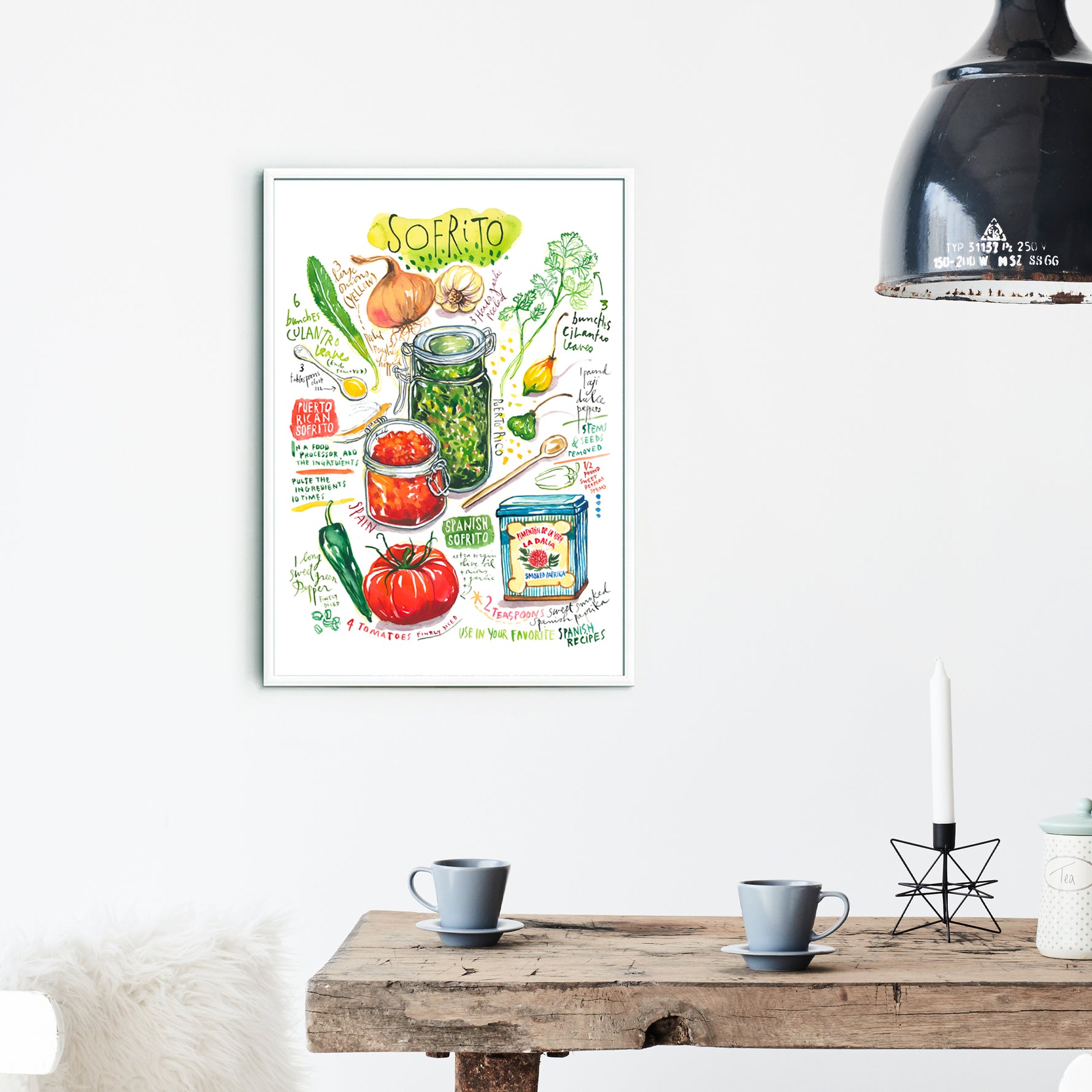 Spanish and Puerto Rican sofrito recipe fine art print in watercolor featuring the ingredients and the finished dish, along with handwritten instructions in English. The framed poster hanging in a dining space.